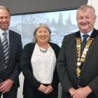 Ashburton deputy mayor Liz McMillan, standing between chief executive Hamish Riach and Mayor Neil...