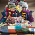 Dianne Schnarr (left) and Margaret Larsen try on some of the warm woollen gear at Fairfield Hall...