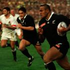 All Blacks winger Jonah Lomu in full flight, with Taine Randell in support, during their team’s...