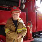 Charles Adams, 5, tries on a firefighter’s uniform. PHOTOS: NIC DUFF