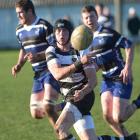 A Kaik player spins the ball away at a premier club rugby match between Kaikorai and Southern at...