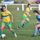 Dunedin City Royals Rose Morton battles with Cashmere Technical and former Royals player Margi...