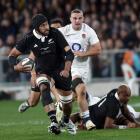 All Blacks lock Patrick Tuipulotu is pursued by England No8 Ben Earl as Mark Tele’a looks on...