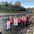 Bayfield High School students clean up the shoreline at Andersons Bay Inlet with support from...