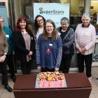 City of Literature South Dunedin "Poet Lorikeet" Jenny Powell  admires a blueberry cheesecake...