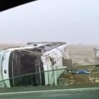 A badly damaged bus lies on its side after crashing off State Highway 8 near Lake Pukaki...