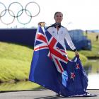 Lydia Ko poses with her gold medal and the New Zealand flag as she celebrates her Olympic victory...