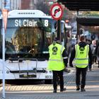 Security guards patrol the bus hub in Great King St on Friday afternoon. PHOTO: GERARD O’BRIEN