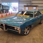 Organising committee member Ian Elstob drives his Pontiac into the Waimumu Field Days site on...