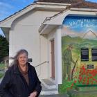 Waimumu Memorial Church owner Lana McMillan stands beside the mural her nephew spray-painted on...