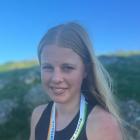 Eastern Southland runner Millie McFadzien, 16, with the gold medal she earned at the Australian...