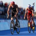 Hayden Wilde of Team NZ leads Max Studer of Team Switzerland during the triathlon mixed relay on...