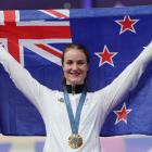 Ellesse Andrews holds the New Zealand flag aloft after being presented her gold medal for the...