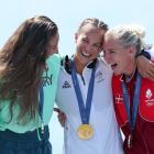 Dame Lisa Carrington (C) with Hungary's silver medallist Tamara Csipes (L) and Denmark's bronze...