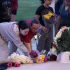 People lay flowers while attending a vigil in Winder, Georgia following the shooting at Apalachee...