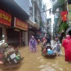 People wade through a flooded street in Hanoi following the impact of Typhoon Yagi. Photo: Reuters