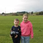 Harrison Sutton and his sister Kyla, 9, stand outside the Kaitangata Rugby Club field, where...