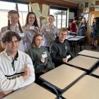 Holding their kindness initiative cards are Dunstan High School students (back, from left)...