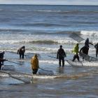 Keen Kakanui River whitebaiters line up at the mouth yesterday. PHOTO: BRENDON MCMAHON