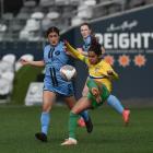 Dunedin City Royals captain Rose Morton (left) tries to defend the pass of Cashmere Technical...