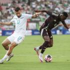 Kosta Barbarouses of New Zealand and Julian Quinones of Mexico vie for the ball in the first half...