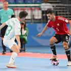 Futsal Whites player Oban Hawkins, of Dunedin, tries to shut down Libyan attacker Siliman...