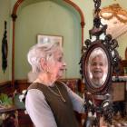 Larnach Castle founding director Margaret Barker examines one of two mirrors made by master...