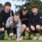 University of Otago commerce student Tommy Cummins, 19, lines up a shot under the eagle eye of...