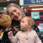 Mosgiel Library librarian assistant Kerri Hayes holds 9-month-old Lyra Parata-Mercer and a Māori...