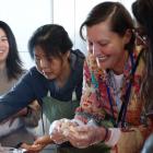 Lisa Wong (left) teaches Waitaki Multicultural playgroup facilitator Justyna Miller how to fold...