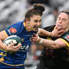 Otago Spirit first five Sheree Hume fends off Wellington defender Alicia Print at Forsyth Barr...