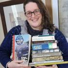 Karen Briscoe with her arms full of books which have been donated for next month’s Bookarama....