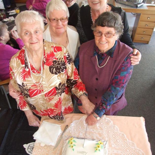 Cutting the birthday cake for Milton Elder Care yesterday are (clockwise from left) Joyce Duncan, the longest-serving  member of Milton Elder Care; Heather Mills, chairwoman of the Milton Elder Care Trust; Ruth Gorton, co-ordinator for the elder care grou