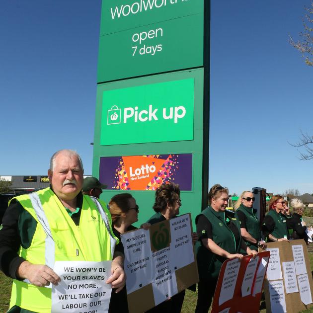 Workers from the Woolworths supermarket in Amberley line State Highway 1 as they protest about...