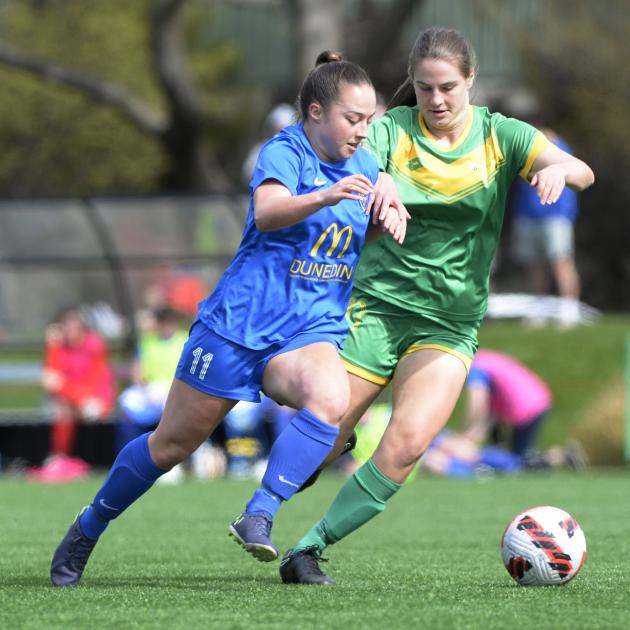 Southern United forward Margi Dias powers past Central defender Jana Niedermayr during the...