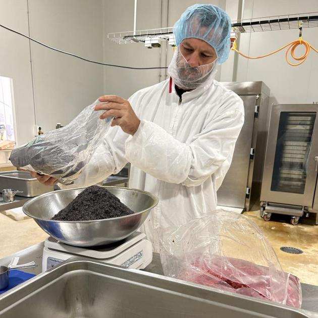 Dan Carson measures nori seaweed and horopito for his next batch of Mīti samples in preparation...