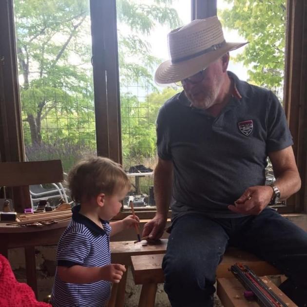 Malcolm Macpherson in his woodworking workshop with grandson James Julian (Jude) Macpherson....