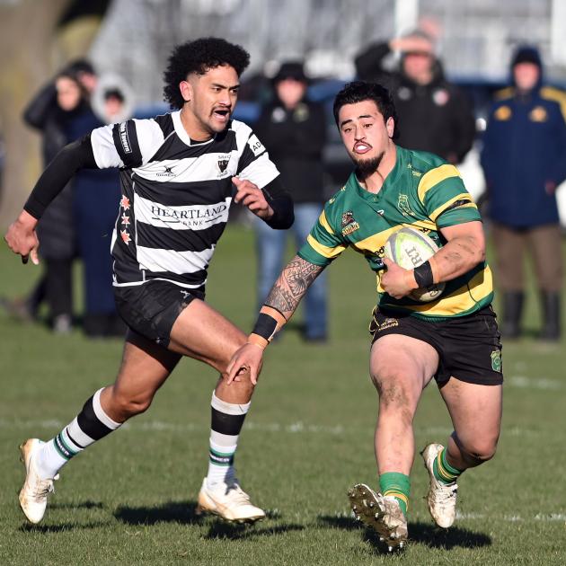 Green Island flanker Jesse Va’afusuaga races past Southern winger Lotu Solomona at Bathgate Park...