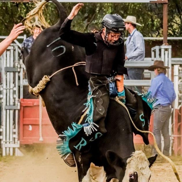Sam Roxburgh (Maniototo Area School) clings on during a rodeo event.