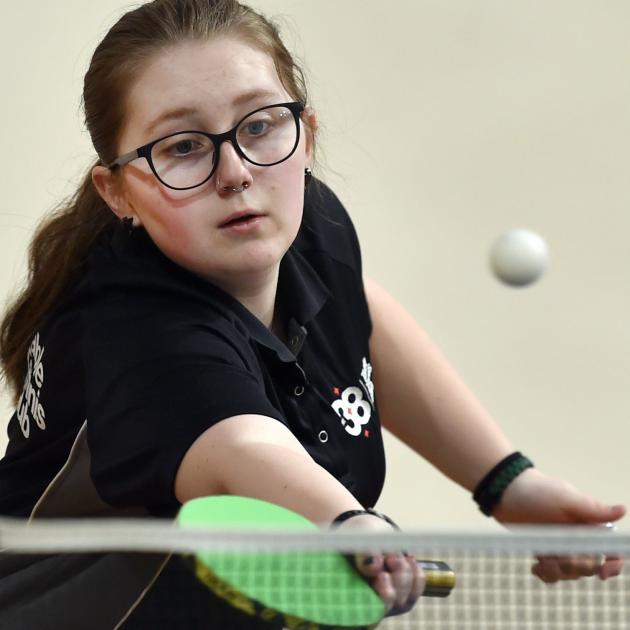 Ella Woodard, 17, of Dunedin, reaches to return a shot during her under-21 singles game.