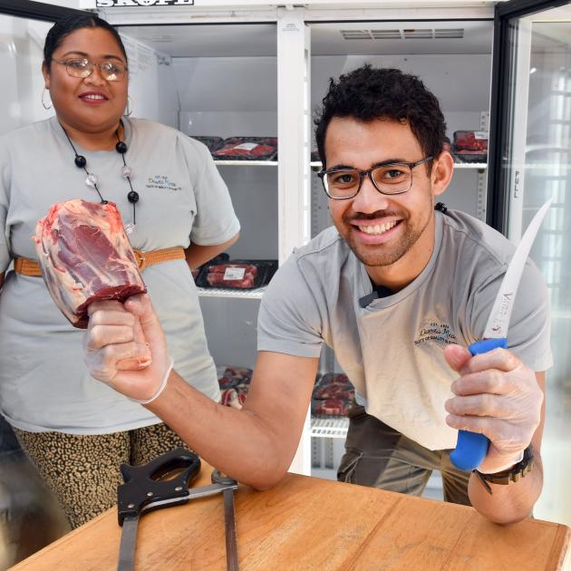 Daveta Meats owner Paula Suguturaga holds a cut of meat nicknamed "Thor’s hammer" as store...