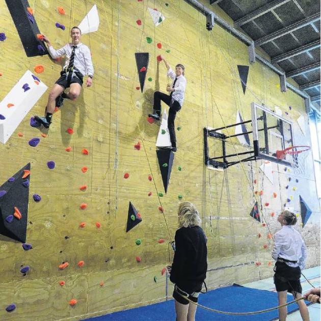 Niko Holgate (left) and Ruben Birt on the climbing wall, supported by ground crew Jett Jansen (at...