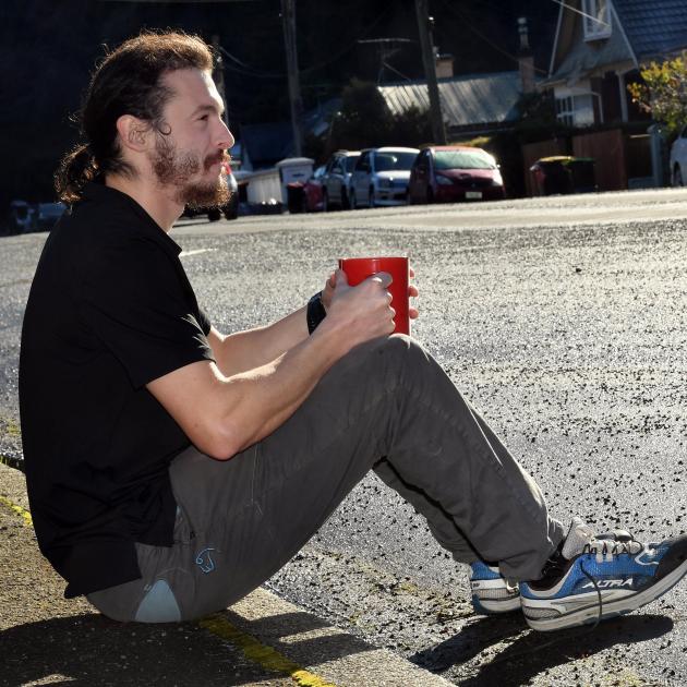 Dunedin resident Isaac Tripp sits on the side of the road where his car should be parked. PHOTO:...