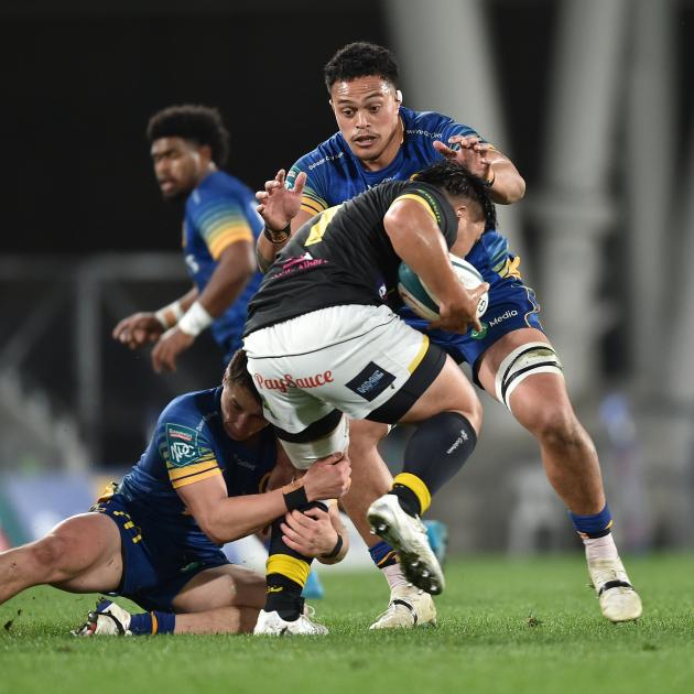 Christian Lio-Willie and Lucas Casey (left) team up to tackle Wellington prop Yota Kamimori...