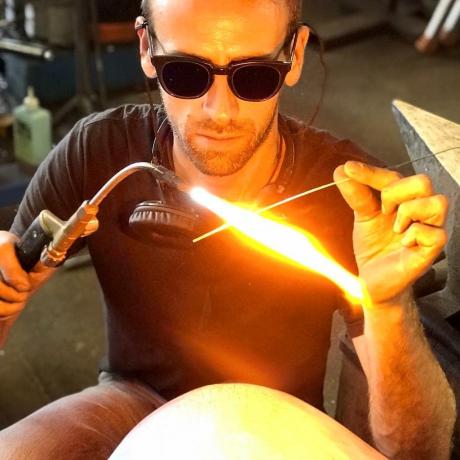 Invercargill-born, award-winning Jake Apiata concentrates on pre-heating a small metal rod before...