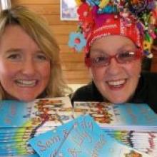 Children's book illustrator Amy Sheehan (left), of Wanaka, and Cardrona skifield host Carol Little with Amy's new book, Sam and Lily at Cardrona. Photo by Marjorie Cook.