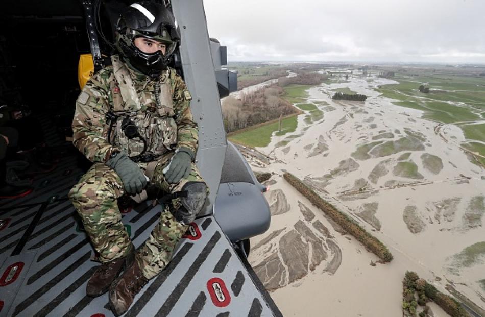 A soldier looks out over the flood damage in Canterbury in June 2021. Photo: Getty Images