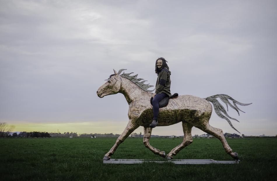 Gawie Bosman on Metallicus, his metal horse sculpture. PHOTO: BEN DOUBLEDAY