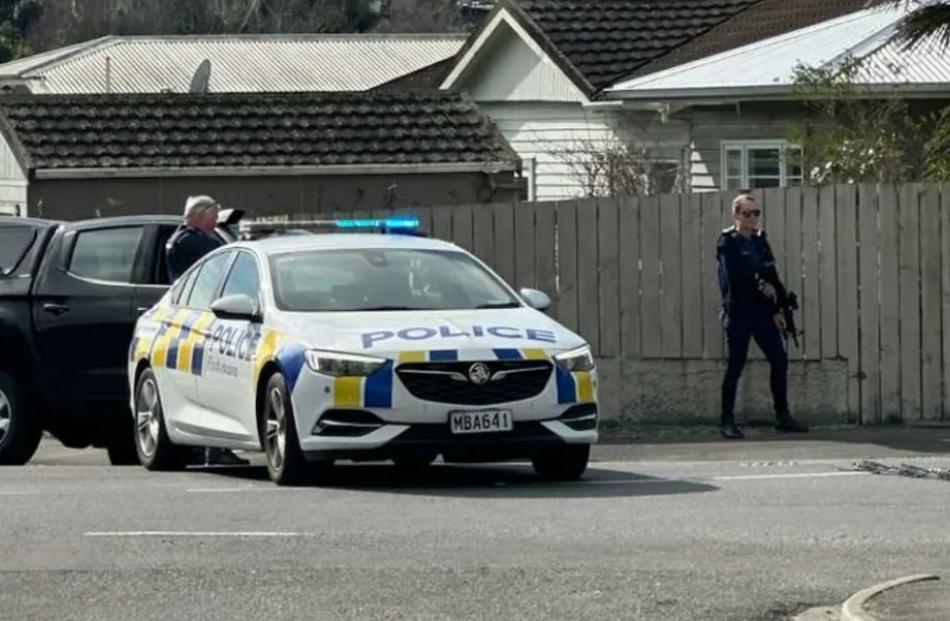 Armed police set up road spikes on Motueka St. Photo: Supplied / RNZ