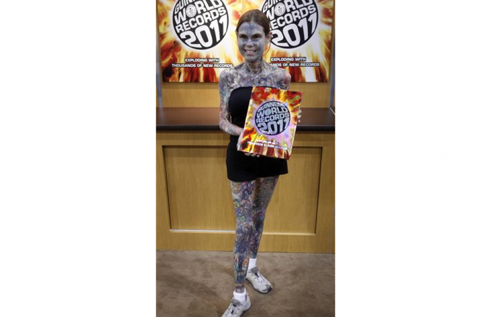 Julia Gnuse holding latest Guinness Book of World Records (AP Photo/Seth We...